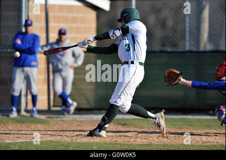 A hitter follows through on his swing after making contact with a pitch during a high school baseball game. USA Stock Photo