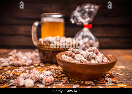 Roasted and salted peanuts in wooden bowl Stock Photo