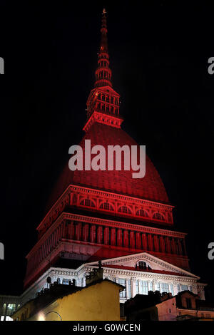 On 4 may, the 67 anniversary of the Superga air disaster, where players of the 'Grande Torino' lost their lives in a plane crash, the symbol of Turin, the Mole Antonelliana is lighted with red-Garnet and the main façade is projected the team's symbol (Photo by: Daniela Parra Saiani/Pacific Press) Stock Photo