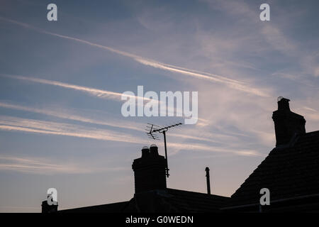 Llansaint, Carmarthenshire, UK. 5th May, 2016. Dawn at about 5:45 am,above hilltop village of Llansaint in Carmarthenshire in West Wales.Clear cloudless sky with plane vapour trails(chemtrails) in the sky.The village is below flight path for planes to and from London area to North America. The weather is forecasted to be sunny throughout the day with little wind. Start of a predicted heat wave. Credit:  Paul Quayle/Alamy Live News Stock Photo