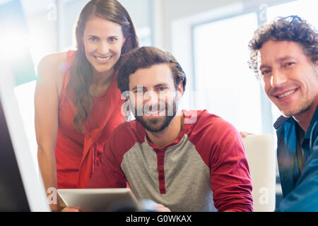 Smiling colleagues using a tablet Stock Photo