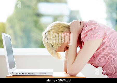 Girl stressed using computer Stock Photo