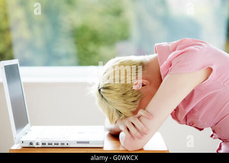 Girl stressed using computer Stock Photo