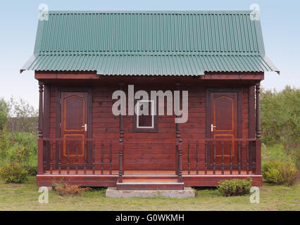 Wooden House Under Green Metal Roof House Behind The Green Fence