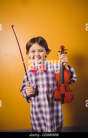 A little boy holding a violin Stock Photo