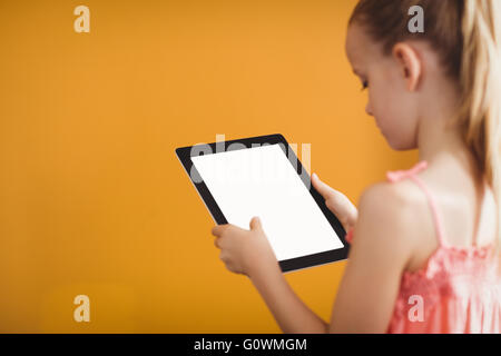Rear view of girl using a tablet Stock Photo