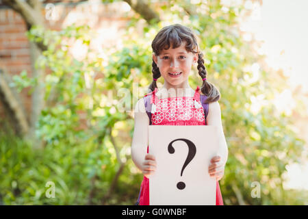Girl holding a sign with a question mark Stock Photo