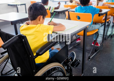 Concentrated pupil working at her desk in a classroom Stock Photo - Alamy