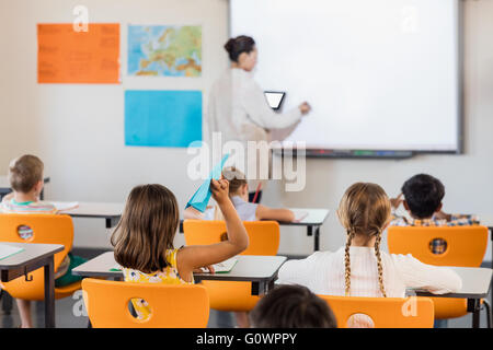 Teacher giving lesson to her students Stock Photo