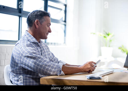 Profile view of a serious man using a smartphone Stock Photo