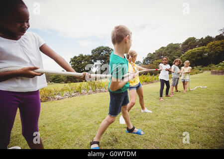 Children pulling a rope in tug of war Stock Photo