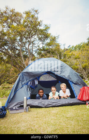 Smiling children lying in the tent Stock Photo