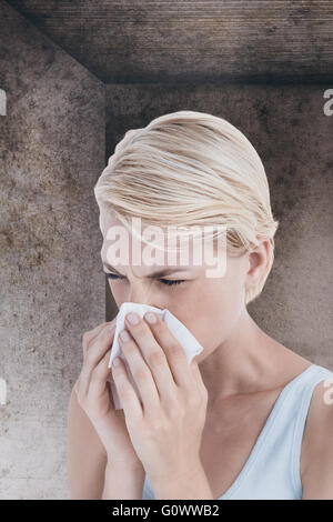 Composite image of portrait of woman blowing her nose Stock Photo