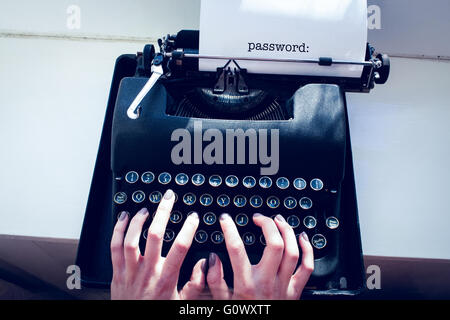 Password: against womans hand typing on typewriter Stock Photo