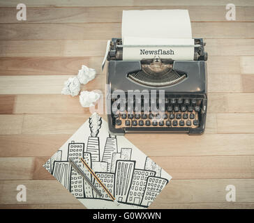 Newsflash against typewriter and paper on table in office Stock Photo