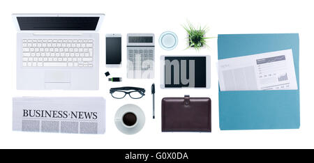 Hi-tech business desktop with computer, smartphone, paperwork and business news, top view on white background Stock Photo