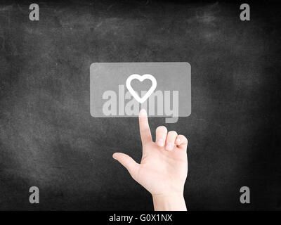 Finger tapping on an icon to symbolize a heart Stock Photo