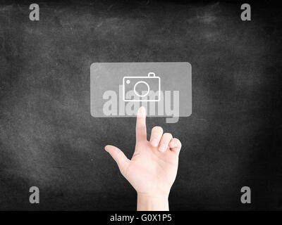 Finger tapping on an icon to symbolize digital photography Stock Photo