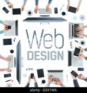 Web designers and developers team working at office desk, text at center, creativity and teamwork concept Stock Photo