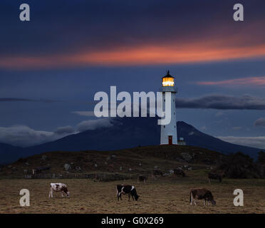 Cape Egmont Lighthouse and Taranaki Mount on background, New Zealand Stock Photo