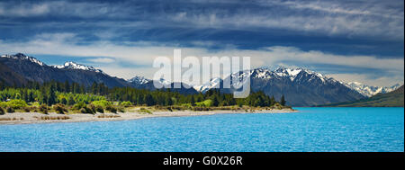 Mountain panorama with turquoise lake and blue sky Stock Photo