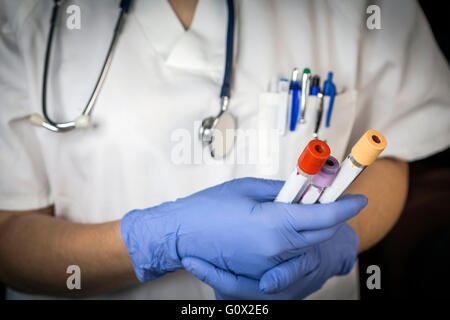 Doctor supports several sample tubes in hospital Stock Photo