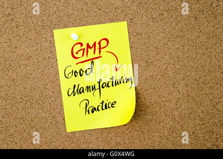 Business Acronym GMP Good Manufacturing Practice written on yellow paper note pinned on cork board with white thumbtack, copy space available Stock Photo
