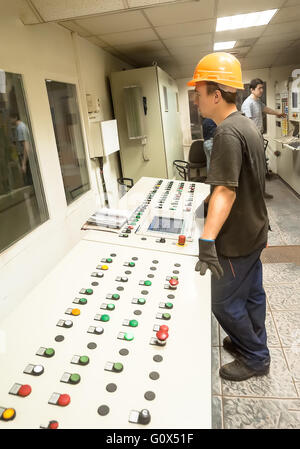 Engineers operate production conveyor Stock Photo