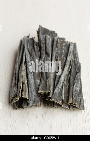 Dried Kombu Algae on white background Stock Photo