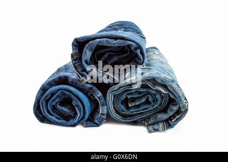 Stack of rolled jeans isolated on white background Stock Photo