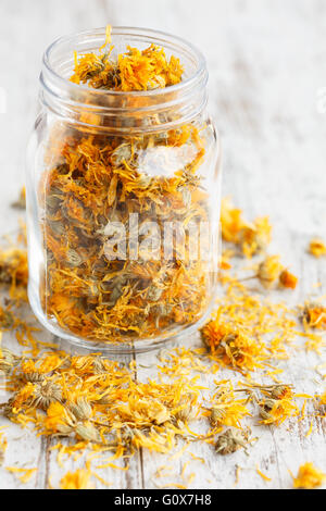 Dried marigold flowers in a glass jar Stock Photo