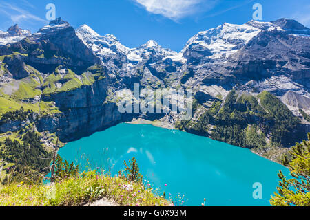 The panorama in summer view over the Oeschinensee (Oeschinen lake) and the alps on the other side near Kandersteg on bernese obe Stock Photo