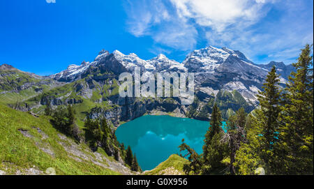 The panorama in summer view over the Oeschinensee (Oeschinen lake) and the alps on the other side near Kandersteg on Bernese Obe Stock Photo
