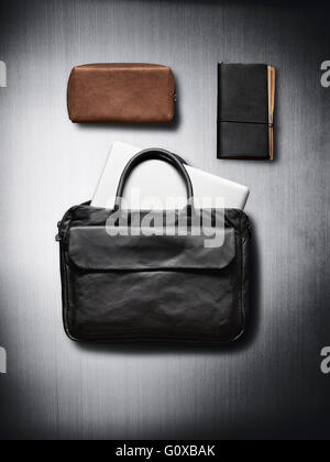 Bags and notebook on metallic background in studio Stock Photo