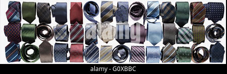 Assortment of ties rolled-up on white background in studio Stock Photo