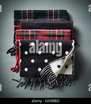 Four scarves on grey background in studio Stock Photo