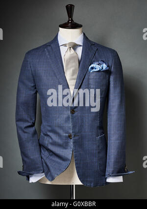 Blue colored suit with tie and handkerchief on bust in studio Stock Photo