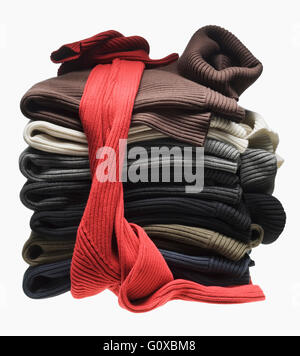 Stack of multi-coloured sweaters on white background Stock Photo