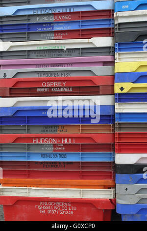Fish boxes stacked on quay. Stock Photo