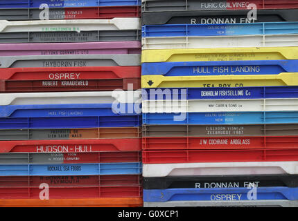 Fish boxes stacked on quay. Stock Photo