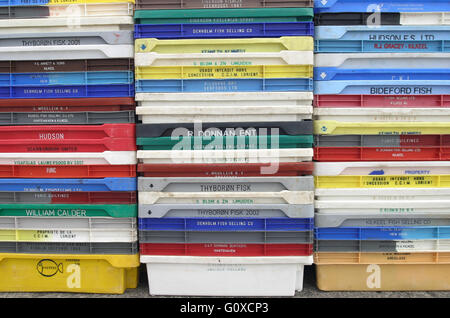 Fish boxes stacked on quay. Stock Photo
