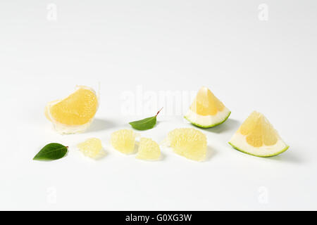 slices of green grapefruit on white background Stock Photo