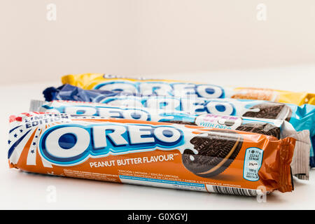 Food. Four packets of different flavoured Oreo biscuits next to each other. First one is peanut butter flavour. Plain white background. Stock Photo