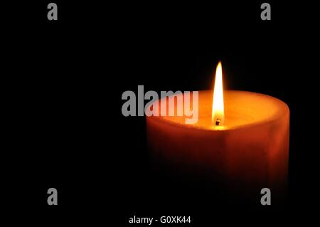 Candle on right of the frame with black background Stock Photo