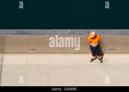 Dock worker seen from above Stock Photo