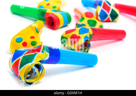 some party horns of different colors on a white background Stock Photo