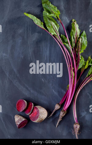 Beet leaves and beetroot on black board Stock Photo