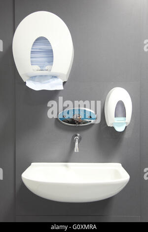A new, touch-sensitive tap in a new hospital A&E department. Also shows basin and soap and paper towel dispensers Stock Photo