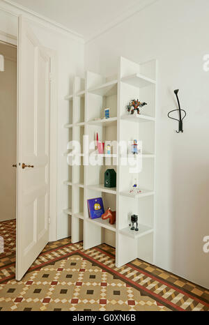 Cervantes Apartment, Barcelona, Spain. A shelving unit in a room with a tiled floor. Stock Photo