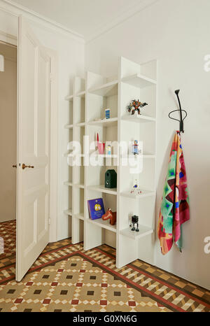 Cervantes Apartment, Barcelona, Spain. A shelving unit in a room with a tiled floor. Stock Photo